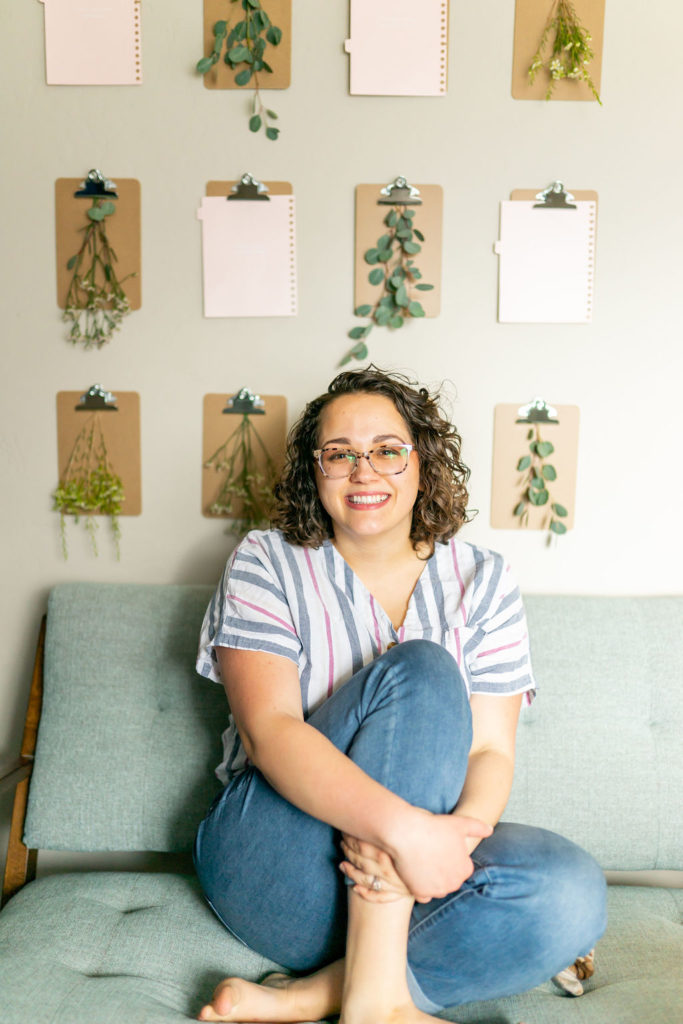 virtual assistant who specializes in SEO sits on a couch for headshots